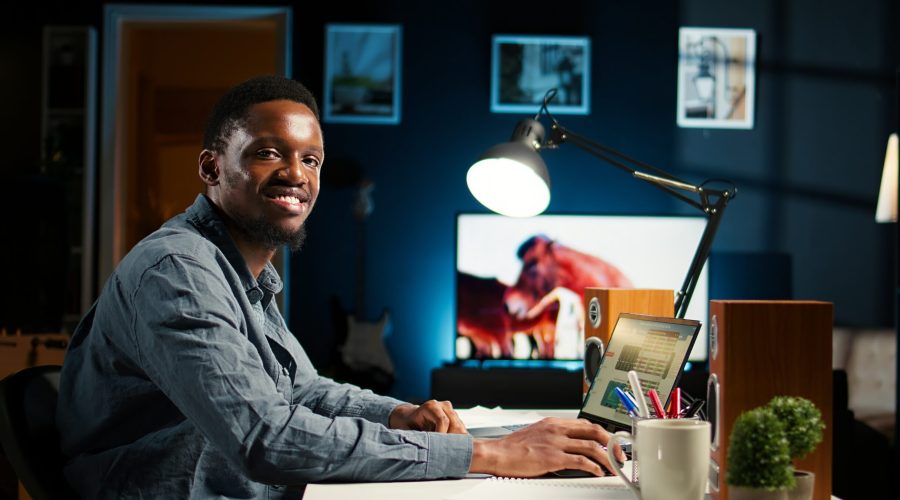 Self employed person working from home and researching different topics, examining online archived information and planning his daily tasks. Remote job setup increasing productivity. Camera A.